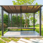A charming garden gazebo with a bench, nestled among vibrant plants and flowers