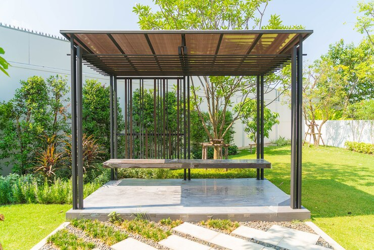 A charming garden gazebo with a bench, nestled among vibrant plants and flowers